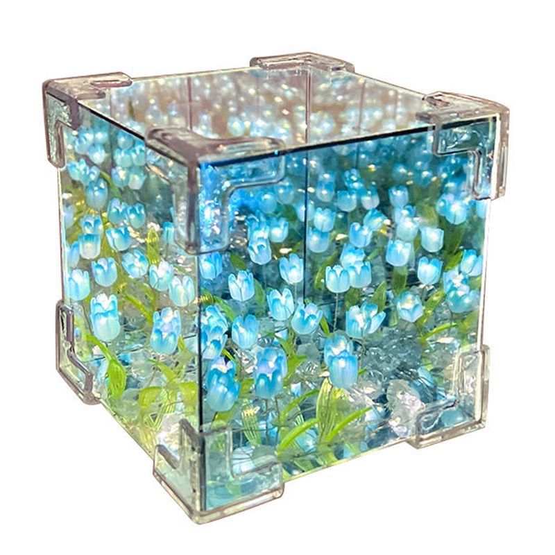 Clear cube with blue tulip flowers inside on a white background