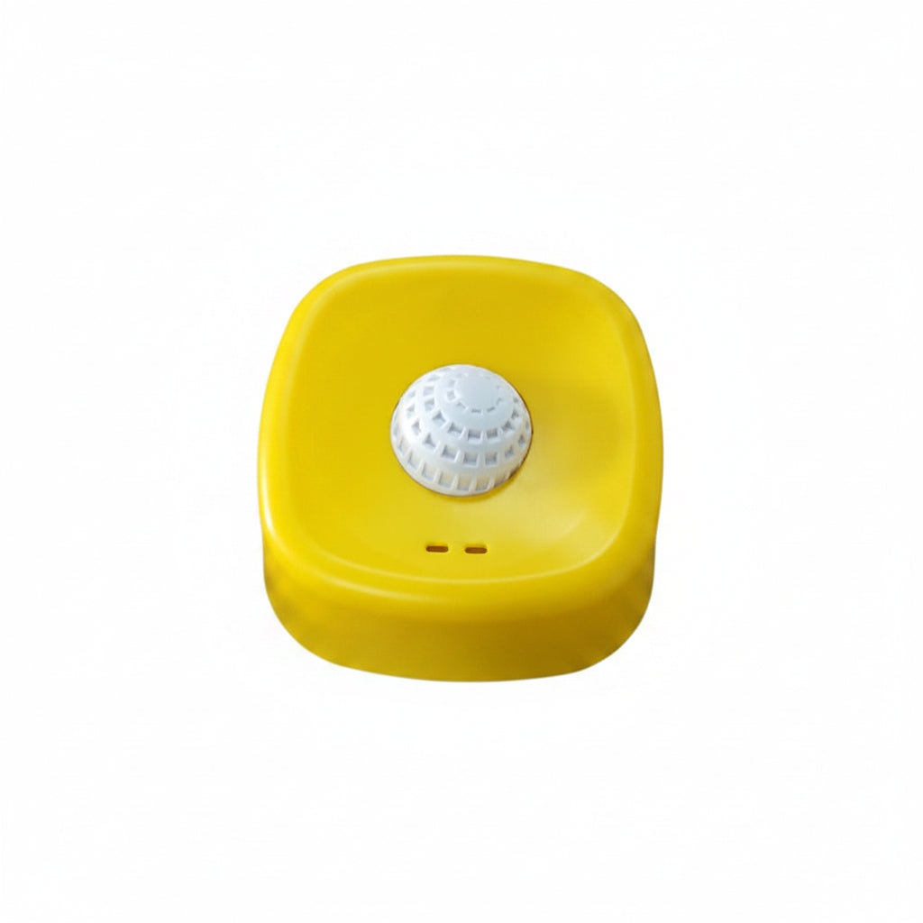 Yellow square device with a white circular component on a white surface