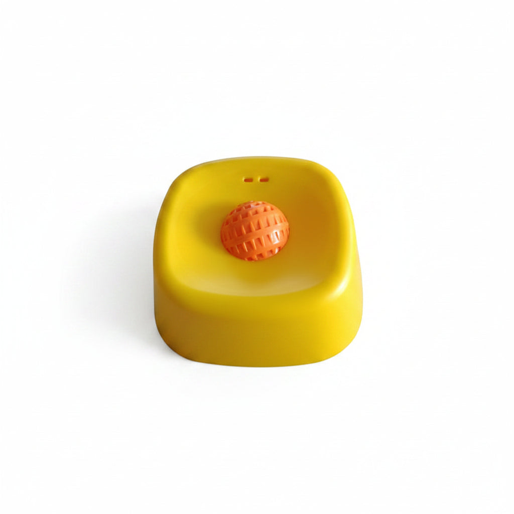 Yellow container with an orange ball on a white surface