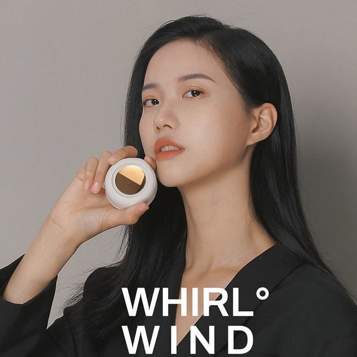 Woman holding a small round object with 'WHIRL WIND' branding on a plain background
