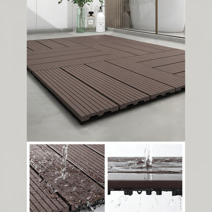 Brown interlocking deck tiles with water drainage feature on a gray floor.